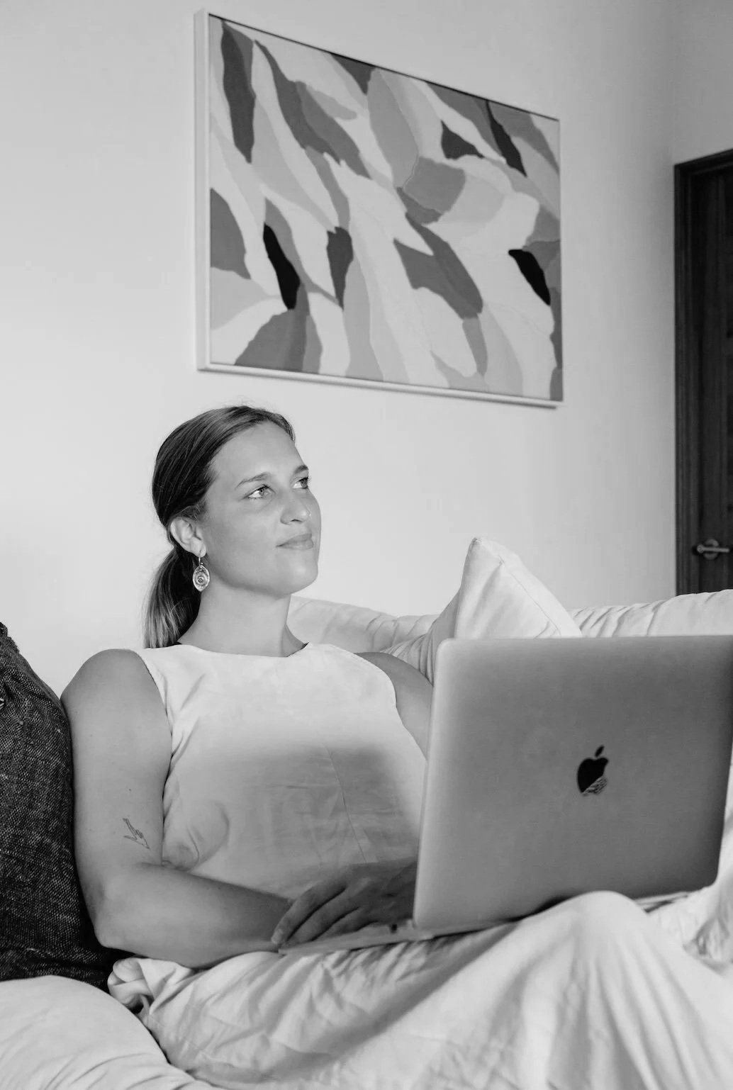 Loes settled on the couch with her laptop during an online call